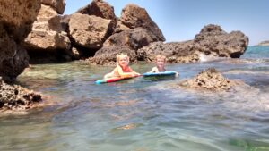 Swimming in the shallow rock pools at the Tsunami beach end of Almyrida