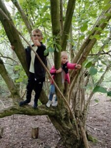 Ralph & Neve climbing trees in the woods